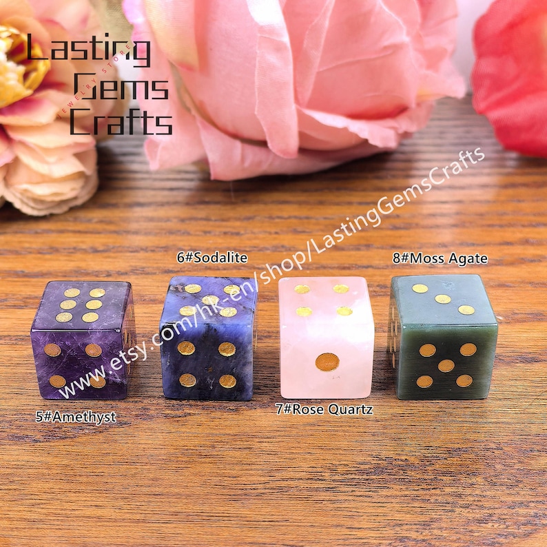 May include: Four gemstone dice in amethyst, sodalite, rose quartz, and moss agate. Each die has gold-colored dots. The image includes text that reads "Lasting Gems Crafts" and "www.etsy.com/hk-en/shop/LastingGemsCrafts".