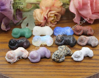 May include: A collection of 12 small, hand-carved sleeping animal figurines made from various types of polished stone. The figurines are in a variety of colors, including green, white, blue, purple, brown, and gray. The figurines are all about 2 inches long and are perfect for adding a touch of whimsy to any home decor.