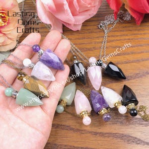May include: A collection of gemstone pendant necklaces in various colors, including amethyst, rose quartz, and black onyx. Each pendant is attached to a silver chain. The image includes the text "Lasting Gems Crafts" and the website address.
