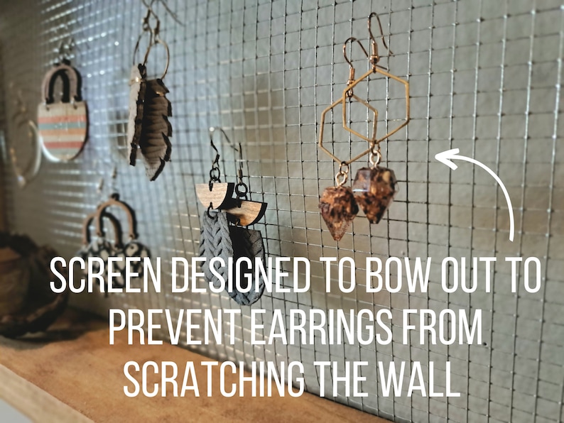 The metal screen is designed to bow out slightly to prevent earrings from scratching the wall.