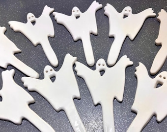 May include: A collection of white ceramic ghost-shaped plant markers. Each piece features a stylized ghost figure with two small circular eyes and an open mouth, attached to a long, narrow stake designed for insertion into soil or potting mix.