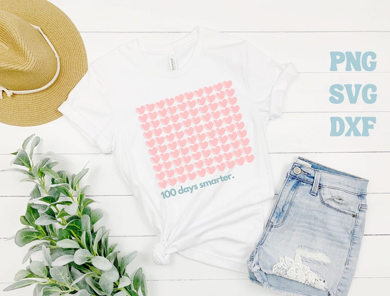 May include: White t-shirt with a pink heart design and the text "100 days smarter."
