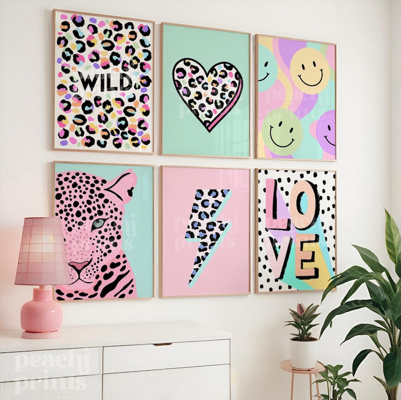 May include: Six framed art prints with a fun, colorful theme. The prints feature leopard print patterns, hearts, smiley faces, a leopard, a lightning bolt, and the words "WILD" and "LOVE". The color palette includes pink, blue, and yellow.