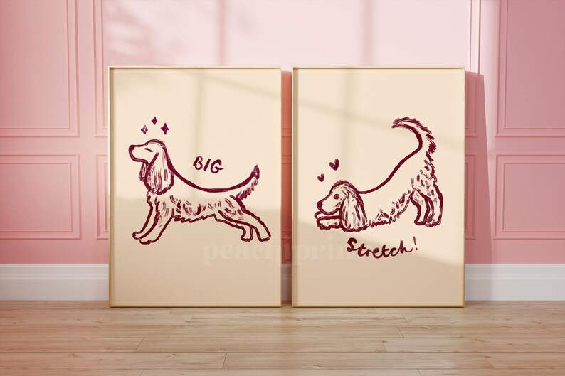 May include: Two framed prints with dog illustrations. One shows a dog with the word "BIG", the other shows a dog stretching with the word "Stretch!". The drawings are in a dark red-brown color on a cream background.