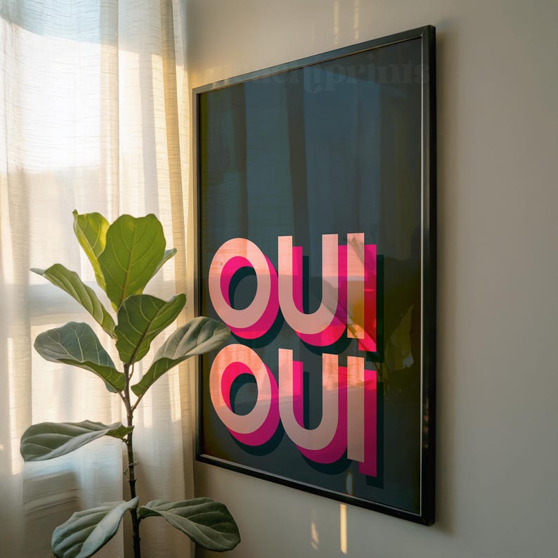 May include: A framed rectangular wall art print featuring a dark teal background with the word "oui" repeated twice in a stacked layout. The letters are rendered in a bold, layered typography style with vibrant pink and light peach color gradients.