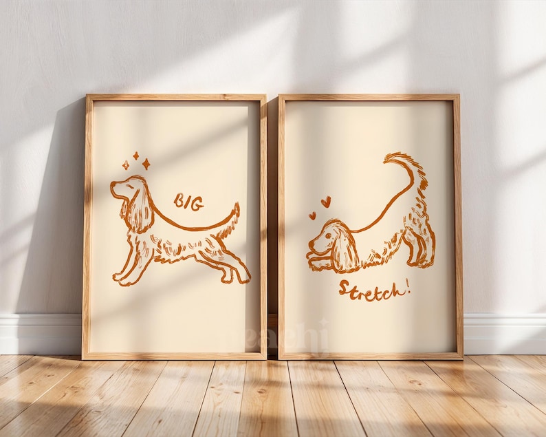 May include: Two framed prints with a light beige background and a brown dog illustration. One print says "BIG" and the other says "Stretch!". The dog illustrations are in a playful, cartoon style, with hearts and stars.
