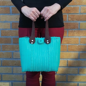 Originally designed handwoven recycled plastic tote bag with suede handles