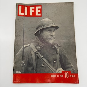 May include: Vintage LIFE magazine cover featuring a portrait of a soldier in uniform and helmet. The magazine's title, "LIFE," is in a red box at the top. The cover also includes the date "March 11, 1940" and the price "10 cents."