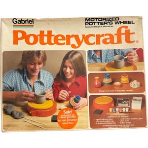 May include: A Gabriel Potterycraft motorized potter's wheel toy set in its original box. The packaging features images of children using the orange and yellow wheel, along with illustrations of painted ceramic pots, paints, and tools.