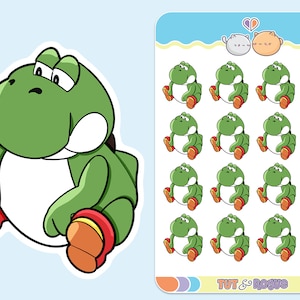May include: A sheet of stickers featuring a green cartoon character with a white belly and red shoes. The character is sitting with its legs crossed and has a sad expression. The sheet also includes a smaller sticker of two cartoon cats with hearts above their heads. The text "TUT & Rogue" is at the bottom of the sheet.