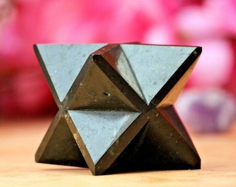 May include: A black obsidian star shaped crystal, also known as a Merkaba, is a geometric shape that is often used in meditation and healing.