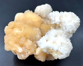 May include: A cluster of white and yellow crystals with a rough, textured surface. The crystals are arranged in a natural, organic shape.