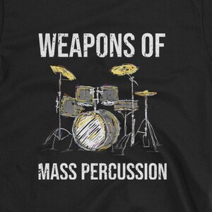 May include: Black t-shirt with a white graphic of a drum set and the text "Weapons of Mass Percussion".