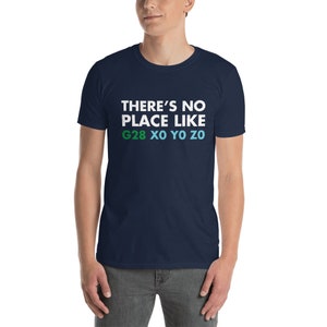 May include: A navy blue t-shirt with white text that reads "THERE'S NO PLACE LIKE G28 XO YO ZO". The text is in a bold, sans-serif font. The letters "G28" are in green, "XO" are in light blue, "YO" are in a darker blue, and "ZO" are in a light blue.