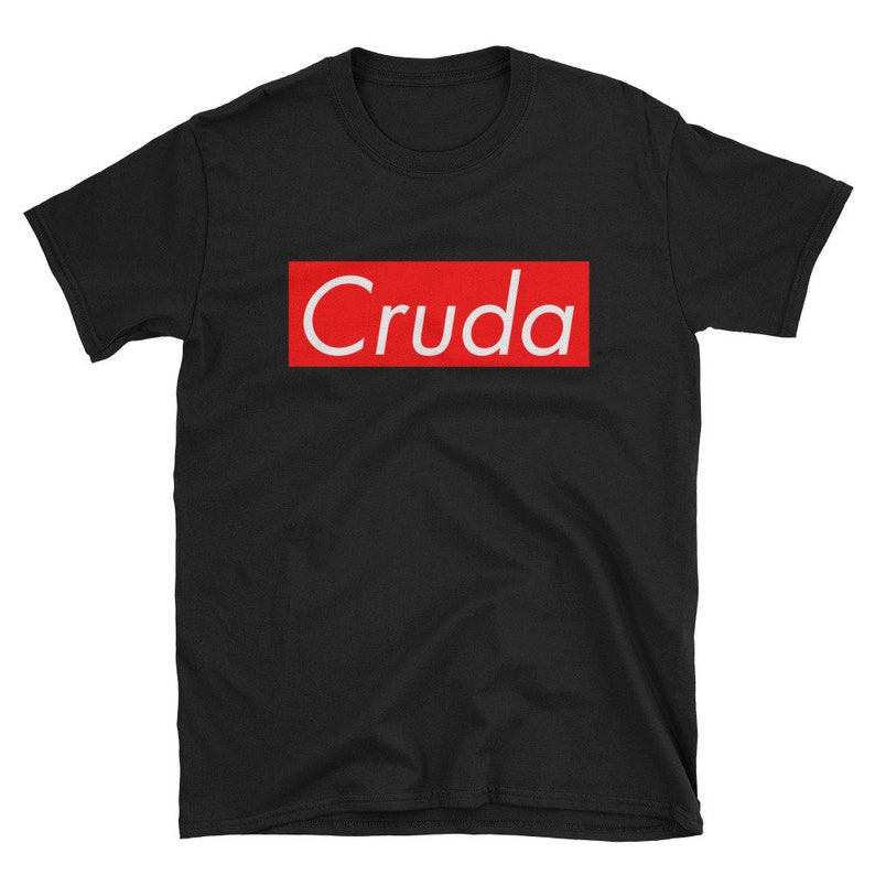 May include: Black t-shirt with a red box and the word "Cruda" in white letters.
