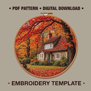 May include: A circular wooden embroidery hoop framing a printed image of a stone cottage surrounded by autumn trees with vibrant red and orange leaves. The text "PDF PATTERN • DIGITAL DOWNLOAD" and "EMBROIDERY TEMPLATE" appears above and below the hoop.