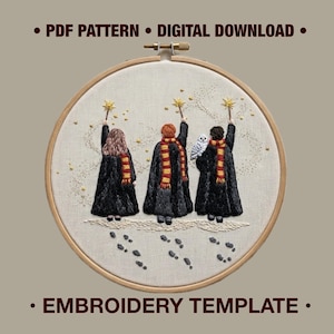 May include: A circular wooden embroidery hoop containing a fabric panel with an embroidered scene of three figures in black robes and red and gold scarves holding wands with gold stars, a white owl, and footprints on a light background. Text: PDF PATTERN DIGITAL DOWNLOAD EMBROIDERY TEMPLATE.