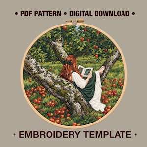 May include: An embroidery hoop containing a needlework scene of a person with long red hair sitting in an apple tree reading a book. The scene features green foliage, red apples on the tree and ground, and the text PDF PATTERN DIGITAL DOWNLOAD EMBROIDERY TEMPLATE.