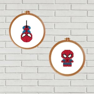 May include: Two embroidery hoop patterns featuring a red and blue cartoon Spiderman. One pattern shows Spiderman hanging upside down, the other shows Spiderman standing.