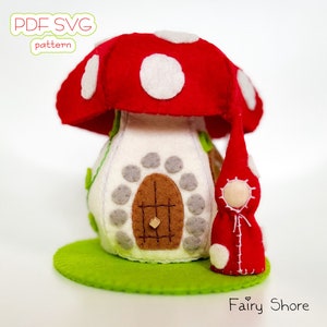 May include: A felt mushroom house with a red roof and white spots, a brown door, and a small red felt gnome standing in front. The house is sitting on a green felt base. The text "PDF SVG pattern" and "Fairy Shore" are visible in the image.