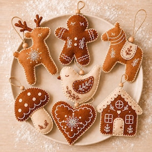 May include: A collection of seven felt ornaments featuring a reindeer, gingerbread person, horse, bird, mushroom, heart, and house. Each brown and cream ornament has white embroidered details and a small wooden bead attached to a hanging string.