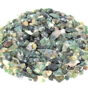 May include: A pile of green, brown, and white agate chips. The chips are various sizes and shapes.