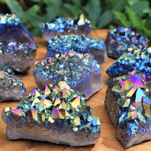 Assortment of Rainbow Aura Amethyst Crystal Clusters on a display board