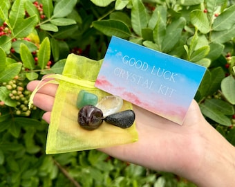 May include: A yellow pouch with a variety of crystals inside. The pouch is labeled "Good Luck Crystal Kit".