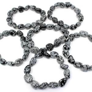 May include: Five black and white snowflake obsidian bracelets. Each bracelet is made of tumbled stones and is approximately 7 inches in length.