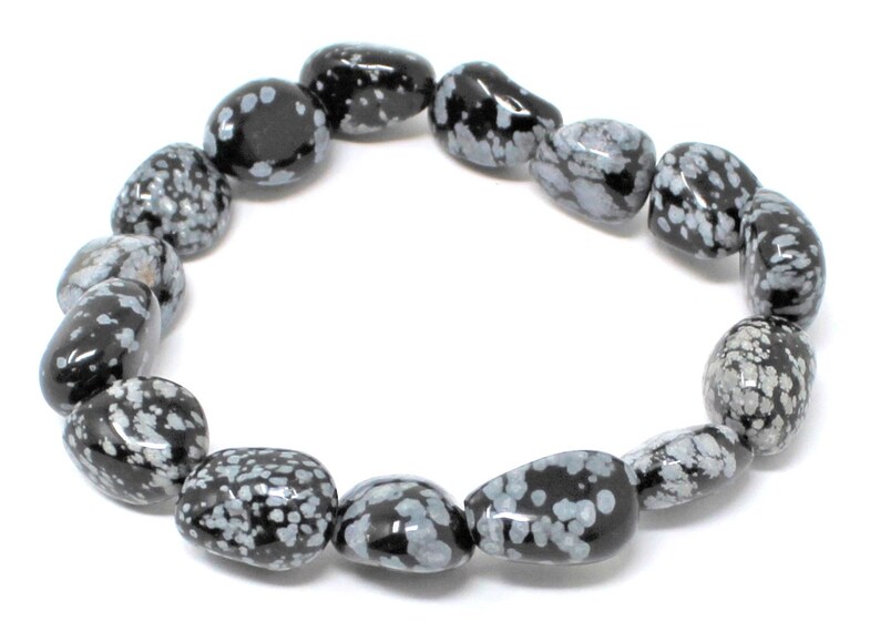 May include: A black and white snowflake obsidian bracelet with smooth, rounded beads.