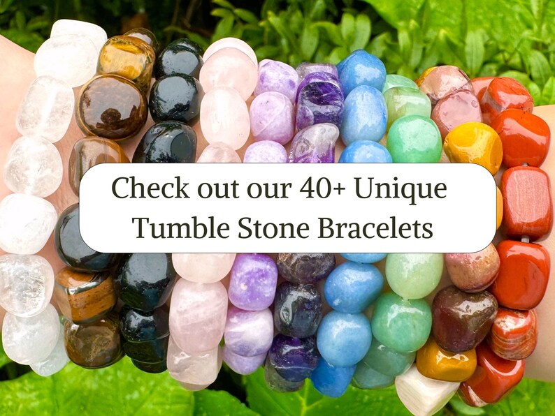 May include: A collection of multi-colored tumble stone bracelets featuring various polished gemstones in white, brown, black, pink, purple, blue, green, yellow, and red. A white rectangular overlay displays the text: Check out our 40+ Unique Tumble Stone Bracelets.