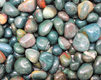 May include: A collection of smooth, polished green, red, and brown stones. The stones are tumbled and have a natural, earthy look.