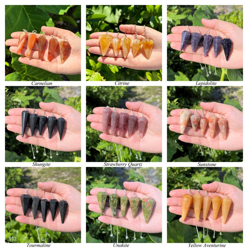 May include: A set of 10 different colored crystal pendulums, each with a silver chain. The pendulums are arranged in three rows of three, with one pendulum in the center row. The pendulums are made of carnelian, citrine, lepidolite, shungite, strawberry quartz, sunstone, tourmaline, unakite, and yellow aventurine.
