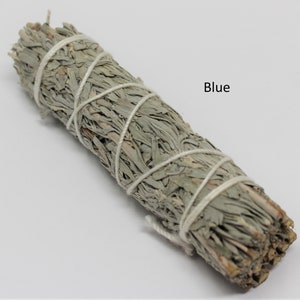 May include: A bundle of dried sage, tied with white string, for smudging. The sage is a light gray color and the text "Blue" is written in black letters on a white background.