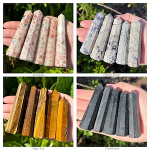 May include: Four sets of four polished crystal towers. The first set features peach and white sunstone. The second set displays mottled purple and white tiffany stone. The third set shows golden-brown tiger eye. The fourth set consists of black tourmaline.