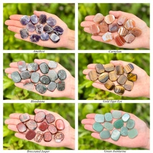 May include: A collection of polished gemstones, including amethyst, carnelian, bloodstone, gold tiger eye, brecciated jasper, and green aventurine. Each type is displayed in a hand, showcasing their unique colors and textures. The names of the stones are labeled below each group.