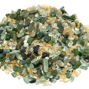 May include: A collection of small, tumbled gemstones in various shades of green, ranging from light mint to deep forest green, mixed with translucent yellow and clear quartz-like crystal chips. The stones have smooth, rounded, and irregular shapes.