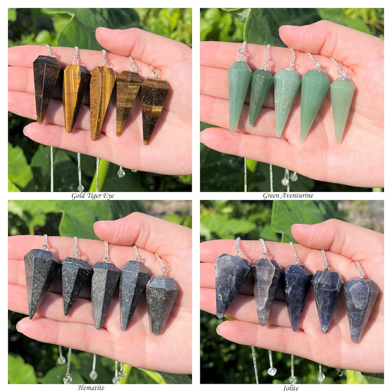 May include: Set of five crystal pendulums in four different colors: gold tiger eye, green aventurine, hematite, and iolite. Each pendulum is a pointed, faceted crystal on a silver chain.