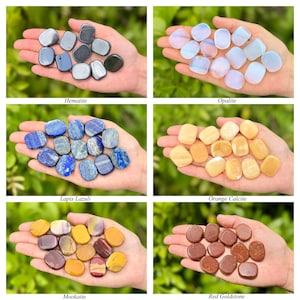 May include: A collection of polished gemstones, including Hematite, Opalite, Lapis Lazuli, Orange Calcite, Mookaite, and Red Goldstone. Each type of stone is displayed in a hand, showcasing their unique colors and textures. The names of the stones are labeled below each group.