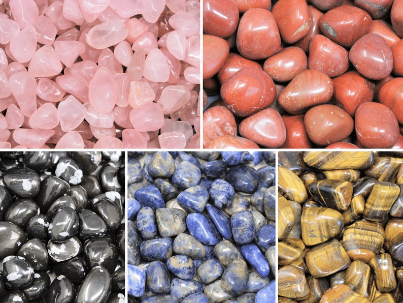 May include: A collection of tumbled stones in various colors, including pink, red, black, blue, and brown. The stones are smooth and polished, and they are arranged in a grid pattern.
