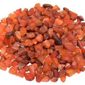 May include: A pile of small, orange-red carnelian stones. The stones are tumbled and have a smooth, polished finish.
