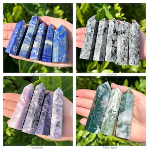 May include: A collection of four sets of polished crystal towers, including blue Lapis Lazuli, grey Larvikite, purple Lepidolite, and green Moss Agate. Each set features multiple pointed stone pillars with distinct natural patterns and textures.