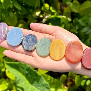 May include: Seven smooth, round, polished stones in a rainbow of colors, including amethyst, blue lace agate, lapis lazuli, green aventurine, citrine, carnelian, and red jasper.