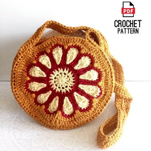 May include: Crochet pattern for a round, mustard yellow crossbody bag with a red and cream flower design. The pattern is available as a PDF download.