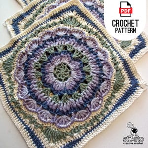 May include: A crochet pattern for a square with a floral design in shades of blue, green, and purple. The pattern is available as a PDF download. The text "CROCHET PATTERN" is visible in the image.
