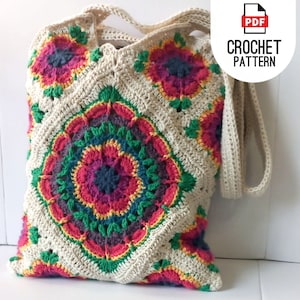May include: A crocheted tote bag with a colorful floral design. The bag has a long strap and is made with a beige yarn.