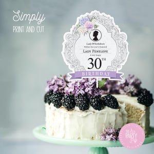 May include: A white cake with purple flowers and blackberries, topped with a decorative cake topper that says "Lady Penelope 30th Birthday". The cake topper is in a vintage style with a floral design and a silhouette of a woman.