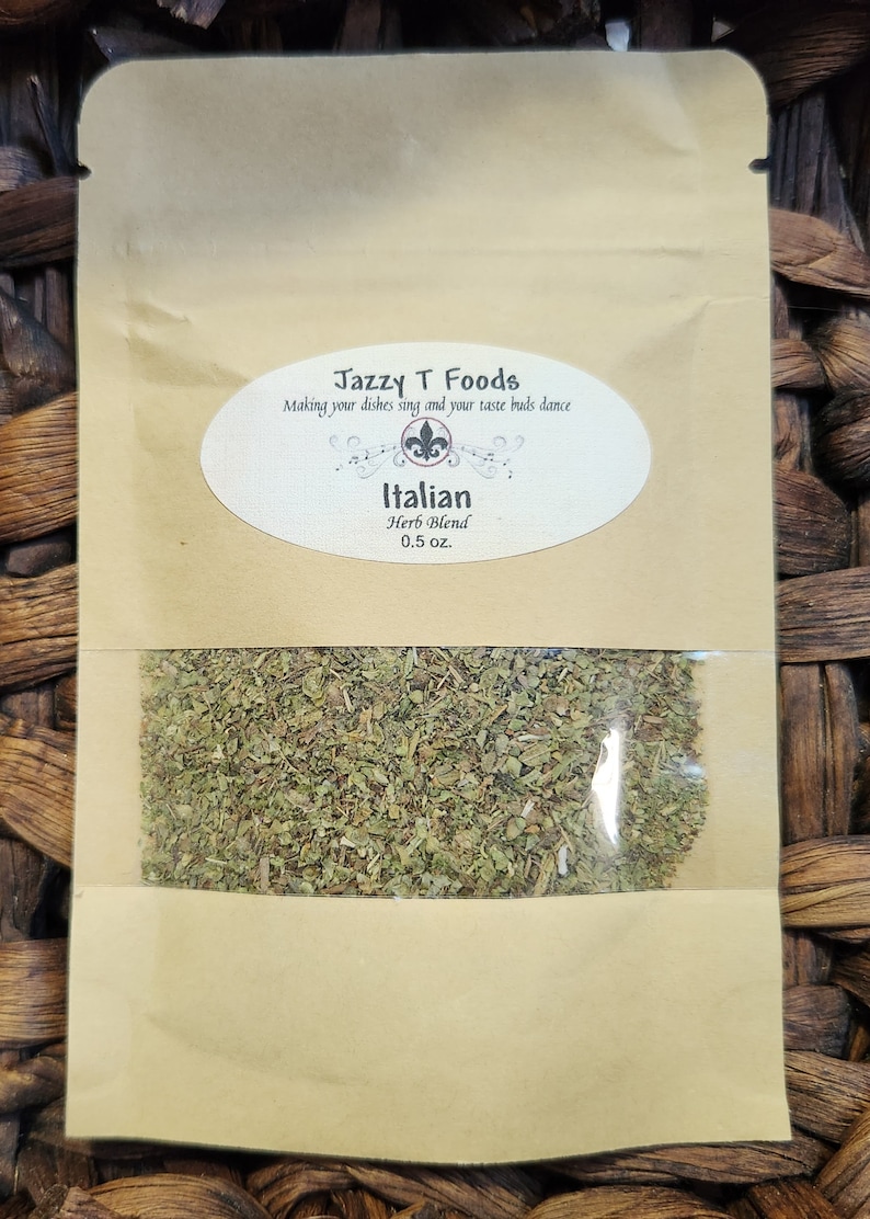 May include: A brown paper bag with a clear window showing dried herbs inside. The bag has a label that reads "Jazzy T Foods" and "Italian Herb Blend 0.5 oz."