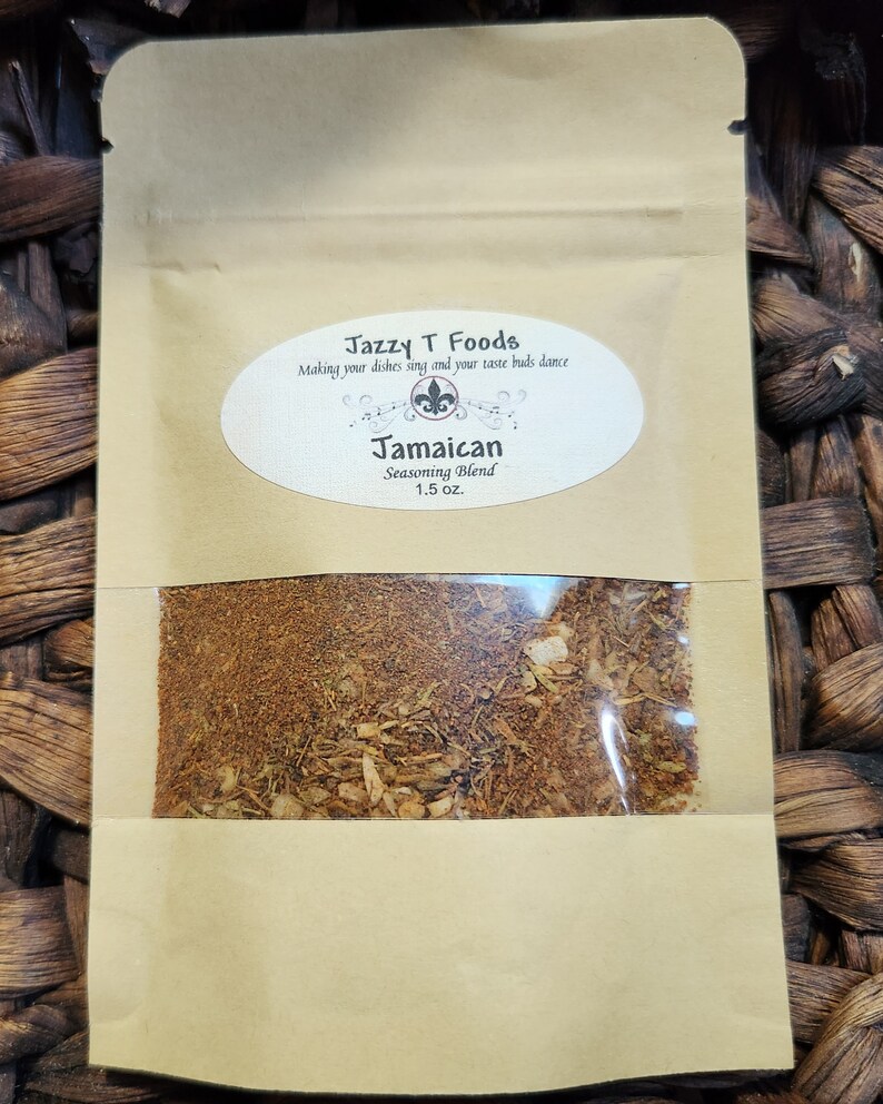 May include: A brown paper pouch with a clear window showing a brown spice blend. The pouch has a label that reads "Jazzy T Foods" and "Jamaican Seasoning Blend 1.5 oz."