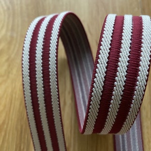 May include: Red and white striped elastic webbing with a textured surface.